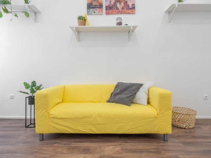 Yellow couch on vinyl plank flooring